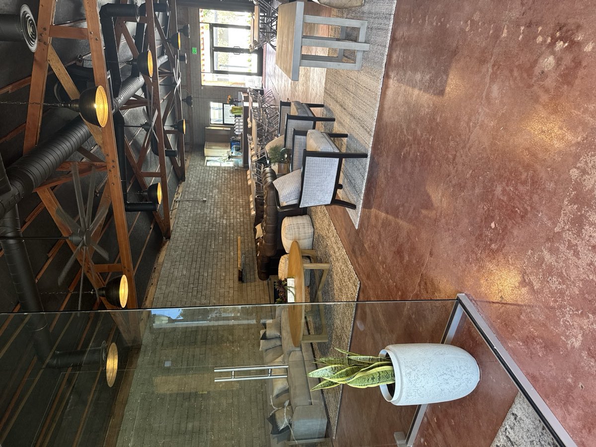 View through the glass partition across the full room to the entry